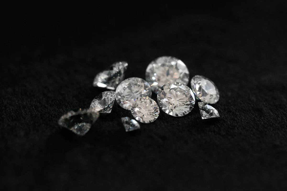 Loose round diamonds photographed on dark fabric for diamond education