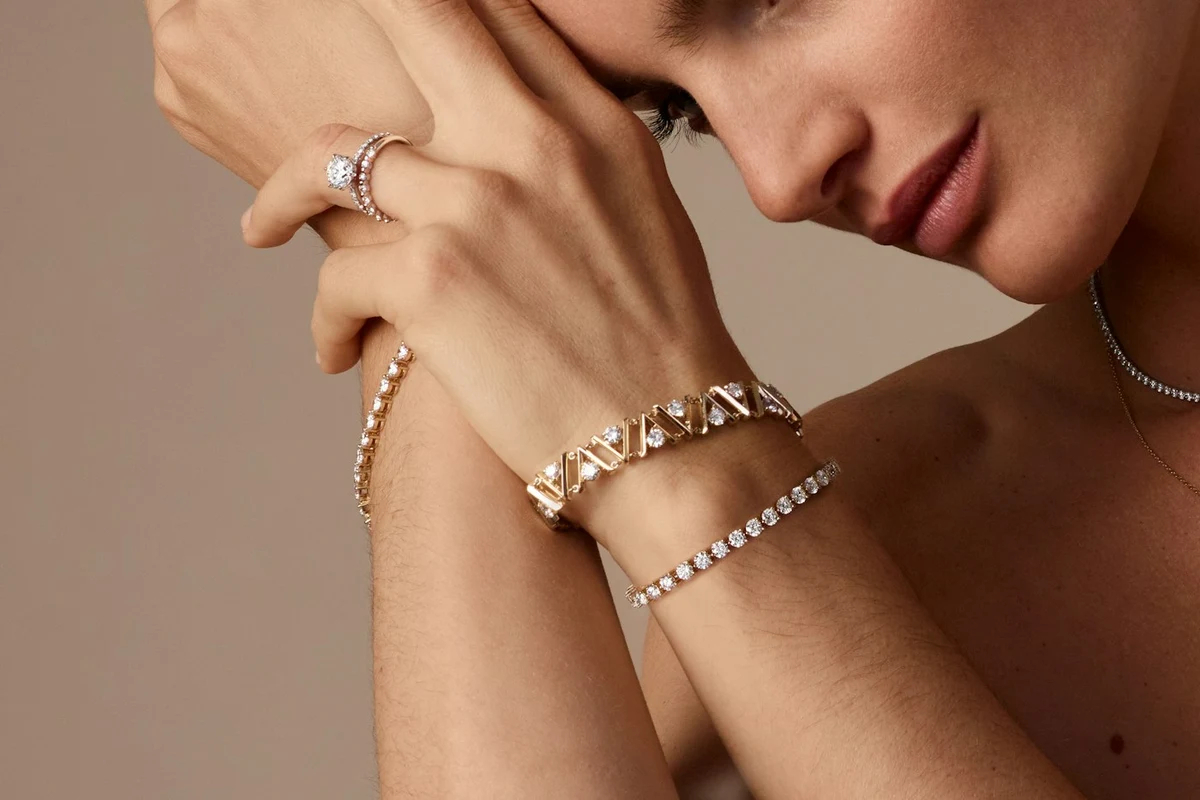 Diamond bracelets and a diamond ring styled on a model’s hand and wrist